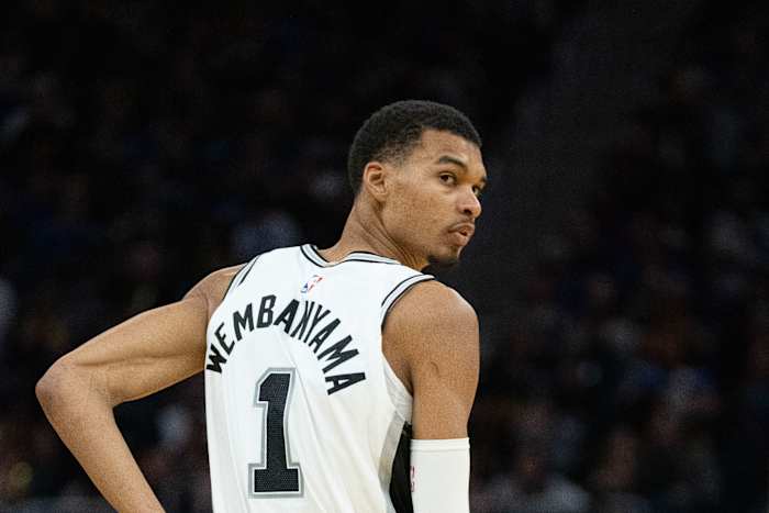 San Antonio Spurs center Victor Wembanyama looks back at a teammate during a game.